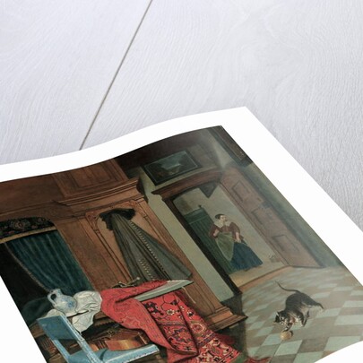 Interior with a carpet, a sword and a jug on a table, a cello on a chair, a coat hanging on a cupboard, a cat playing with a ball, a maid beyond by Cornelis de Man