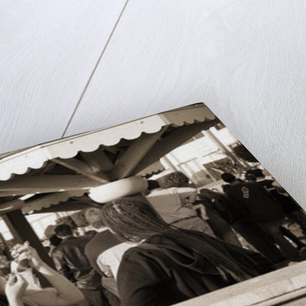 Woman with a pierced tongue applying lipstick, 2004 by Stephen Spiller