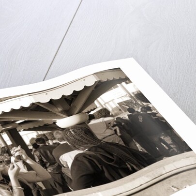 Woman with a pierced tongue applying lipstick, 2004 by Stephen Spiller