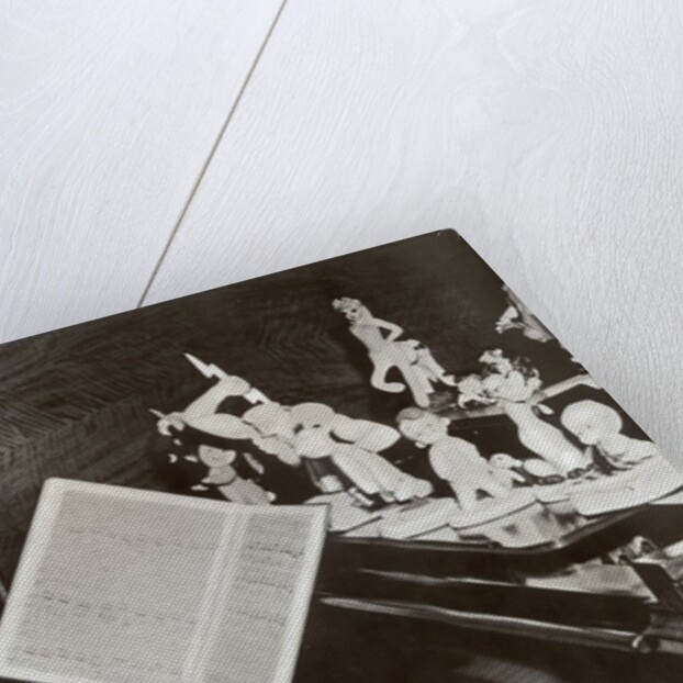 Walt Disney plays piano to a group of figures of Disney characters, c.1940 by German Photographer