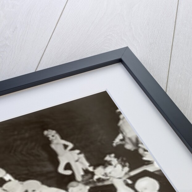 Walt Disney plays piano to a group of figures of Disney characters, c.1940 by German Photographer