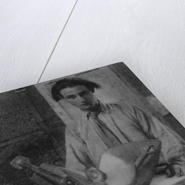 Henri Gaudier-Brzeska with his sculpture 'Bird Swallowing Fish' in Kettle's Yard, University of Cambridge, 1914 by English Photographer