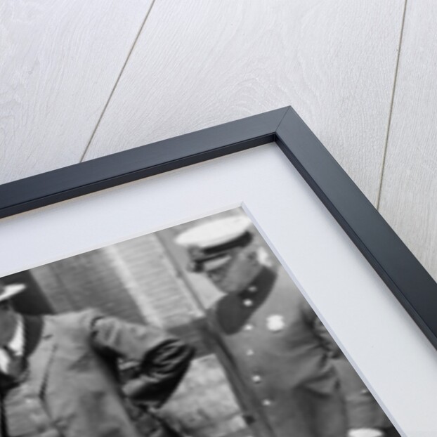 New York City Deputy Police Commissioner John A. Leach, watching agents pour liquor into sewer following a raid during the height of prohibition, c.1921 by American Photographer