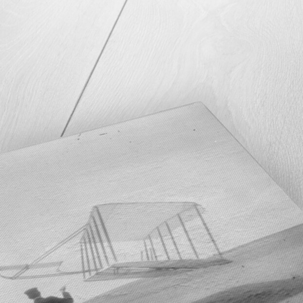 Wilbur Wright at left and Orville Wright at right, with a glider flying as a kite near the ground, 1901 by Anonymous