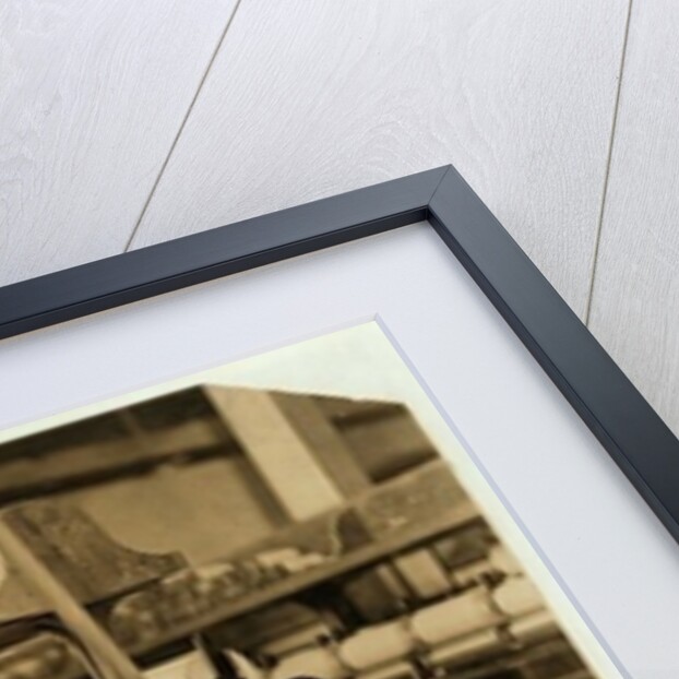 Small boys climbing on spinning frame to mend broken threads and replace empty bobbins at Bibb Mill, Macon, Georgia, 1909 by Lewis Wickes Hine