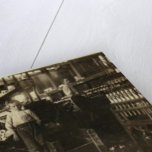 8 year old Leo, only 4 feet tall, picks up bobbins for 15 cents a day at Elk Cotton Mills, Fayetteville, Tennessee, 1910 by Lewis Wickes Hine
