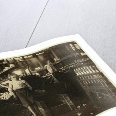 8 year old Leo, only 4 feet tall, picks up bobbins for 15 cents a day at Elk Cotton Mills, Fayetteville, Tennessee, 1910 by Lewis Wickes Hine