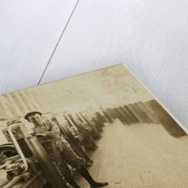 Boy sweeper by carding machines at Lincoln Cotton Mills, Evansville, Indiana in stockinged feet on a slippery floor, 1908 by Lewis Wickes Hine