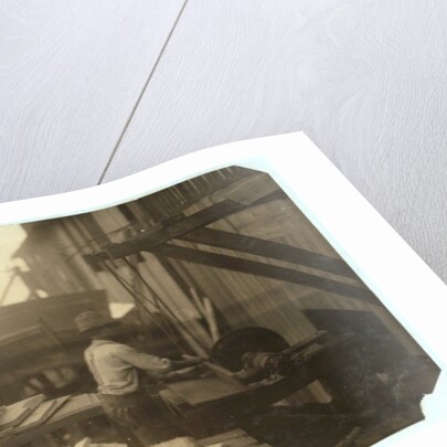 Charlie McBride aged 12 takes wood from a chute for 10 hours at Miller & Vidor Lumber Company, Beaumont, Texas by Lewis Wickes Hine