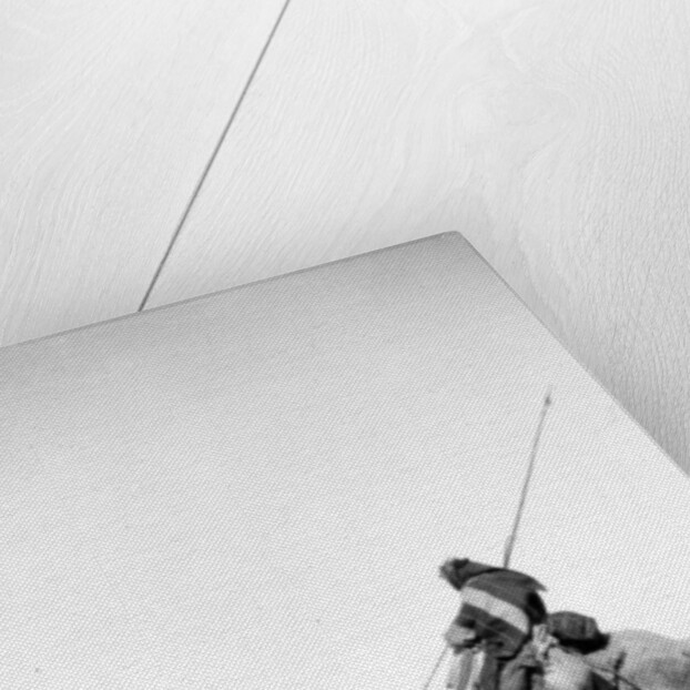 Bedouin warrior making his camel kneel, 1900-20 by Anonymous