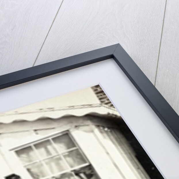 Five Civil War soldiers gathered on dirt porch outside home, African American youth seated near them, 1861-65 by American Photographer