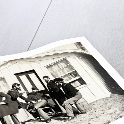Five Civil War soldiers gathered on dirt porch outside home, African American youth seated near them, 1861-65 by American Photographer