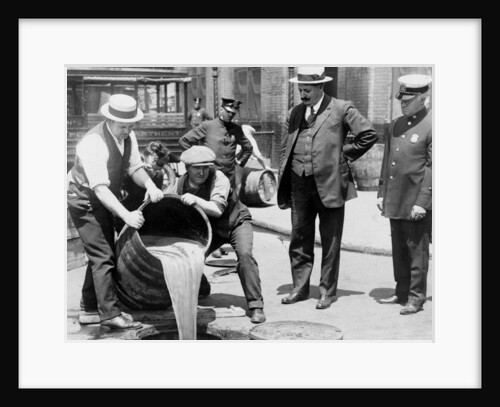 New York City Deputy Police Commissioner John A. Leach, watching agents pour liquor into sewer following a raid during the height of prohibition, c.1921 by American Photographer