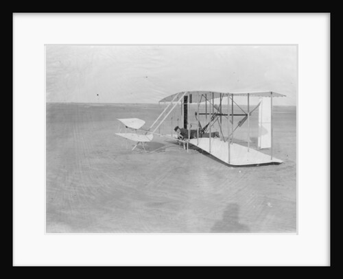 Wilbur in prone position in damaged machine on ground after unsuccessful trial in North Carolina, USA, 1903 by Anonymous