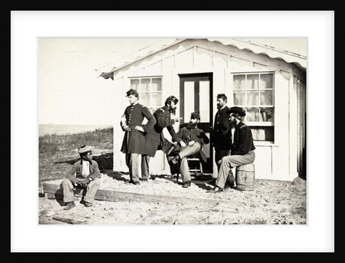 Five Civil War soldiers gathered on dirt porch outside home, African American youth seated near them, 1861-65 by American Photographer