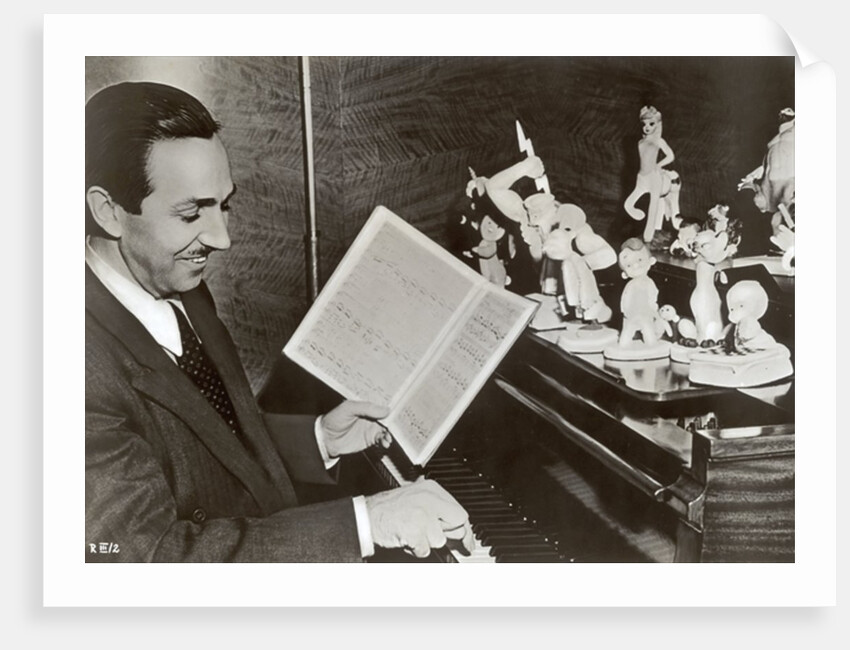 Walt Disney plays piano to a group of figures of Disney characters, c.1940 by German Photographer