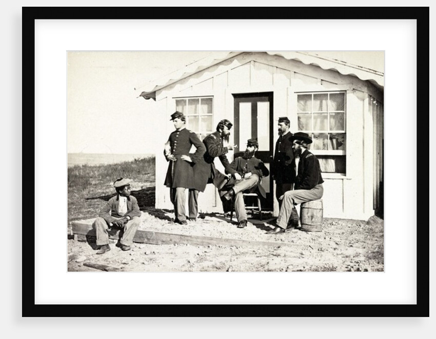 Five Civil War soldiers gathered on dirt porch outside home, African American youth seated near them, 1861-65 by American Photographer