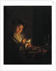 A candlelit interior with a young man seated at a table, lighting his pipe by Arnold Boonen