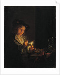 A candlelit interior with a young man seated at a table, lighting his pipe by Arnold Boonen