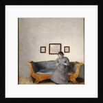 Ida Hammershoi sitting on a sofa by Vilhelm Hammershoi