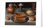 Waffles and butter on pewter plates with an apple, roll, jug, standing salt, and a beer glass with prunts on a cloth-covered table by German School