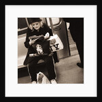 Woman reading on a subway with a Marilyn Monroe purse and an 'I Love New York' bag, 2004 by Anonymous