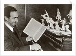 Walt Disney plays piano to a group of figures of Disney characters, c.1940 by German Photographer