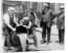 New York City Deputy Police Commissioner John A. Leach, watching agents pour liquor into sewer following a raid during the height of prohibition, c.1921 by American Photographer