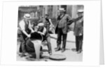 New York City Deputy Police Commissioner John A. Leach, watching agents pour liquor into sewer following a raid during the height of prohibition, c.1921 by American Photographer