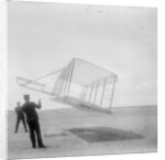 Wilbur Wright at left and Orville Wright at right, with a glider flying as a kite near the ground, 1901 by Anonymous