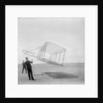 Wilbur Wright at left and Orville Wright at right, with a glider flying as a kite near the ground, 1901 by Anonymous