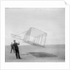 Wilbur Wright at left and Orville Wright at right, with a glider flying as a kite near the ground, 1901 by Anonymous