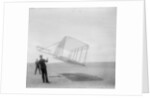 Wilbur Wright at left and Orville Wright at right, with a glider flying as a kite near the ground, 1901 by Anonymous