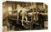 Small boys climbing on spinning frame to mend broken threads and replace empty bobbins at Bibb Mill, Macon, Georgia, 1909 by Lewis Wickes Hine