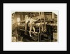 Small boys climbing on spinning frame to mend broken threads and replace empty bobbins at Bibb Mill, Macon, Georgia, 1909 by Lewis Wickes Hine