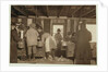 10 year old Mike Murphy, 7 year old Annie Healy and 10 year old Ross Healy in the shucking shed at Alabama Canning Co, Bayou La Batre, Alabama, 1911 by Lewis Wickes Hine
