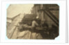 Charlie McBride aged 12 takes wood from a chute for 10 hours at Miller & Vidor Lumber Company, Beaumont, Texas by Lewis Wickes Hine