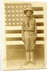 World War I soldier with American flag in background, 1914-18 by American Photographer