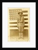World War I soldier with American flag in background, 1914-18 by American Photographer