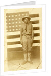 World War I soldier with American flag in background, 1914-18 by American Photographer