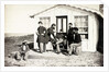 Five Civil War soldiers gathered on dirt porch outside home, African American youth seated near them, 1861-65 by American Photographer