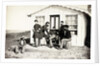 Five Civil War soldiers gathered on dirt porch outside home, African American youth seated near them, 1861-65 by American Photographer