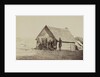 A group of soldiers, and two young men, one an African American, stand outside of log cabin quarters by American Photographer