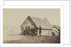 A group of soldiers, and two young men, one an African American, stand outside of log cabin quarters by American Photographer