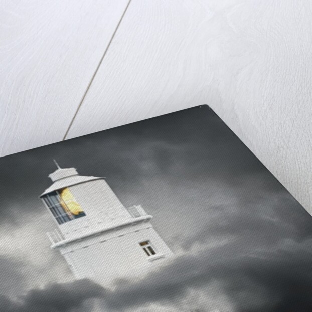Lighthouse Emerging From Dark Clouds by Anonymous