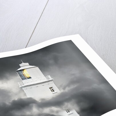Lighthouse Emerging From Dark Clouds by Anonymous