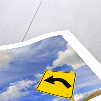 Curve Road Sign on Highway Against Sky by Anonymous