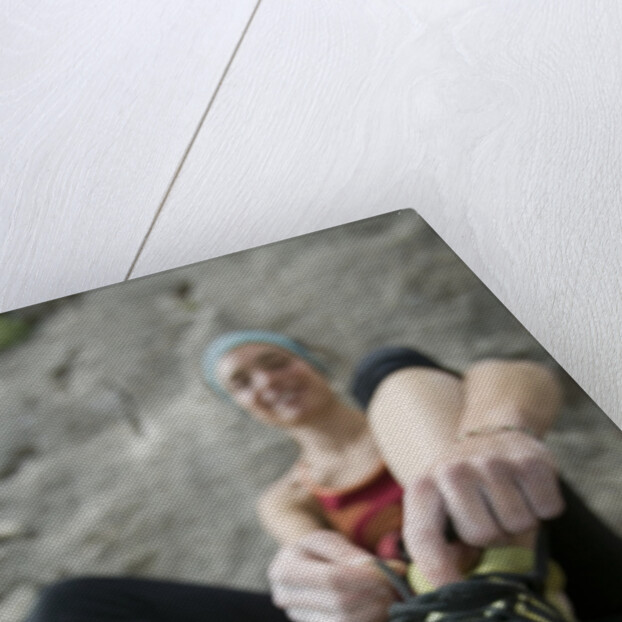 Woman Putting on Rock Climbing Shoes by Anonymous