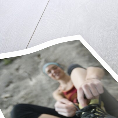 Woman Putting on Rock Climbing Shoes by Anonymous