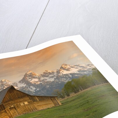 Log Barn in Meadow near Mountain Range by Corbis